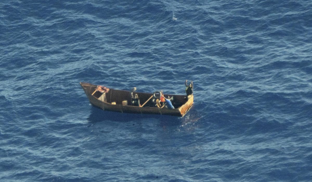 Migrants from dozens of boats reach tiny Italian isles; charity ship rescues hundreds of people